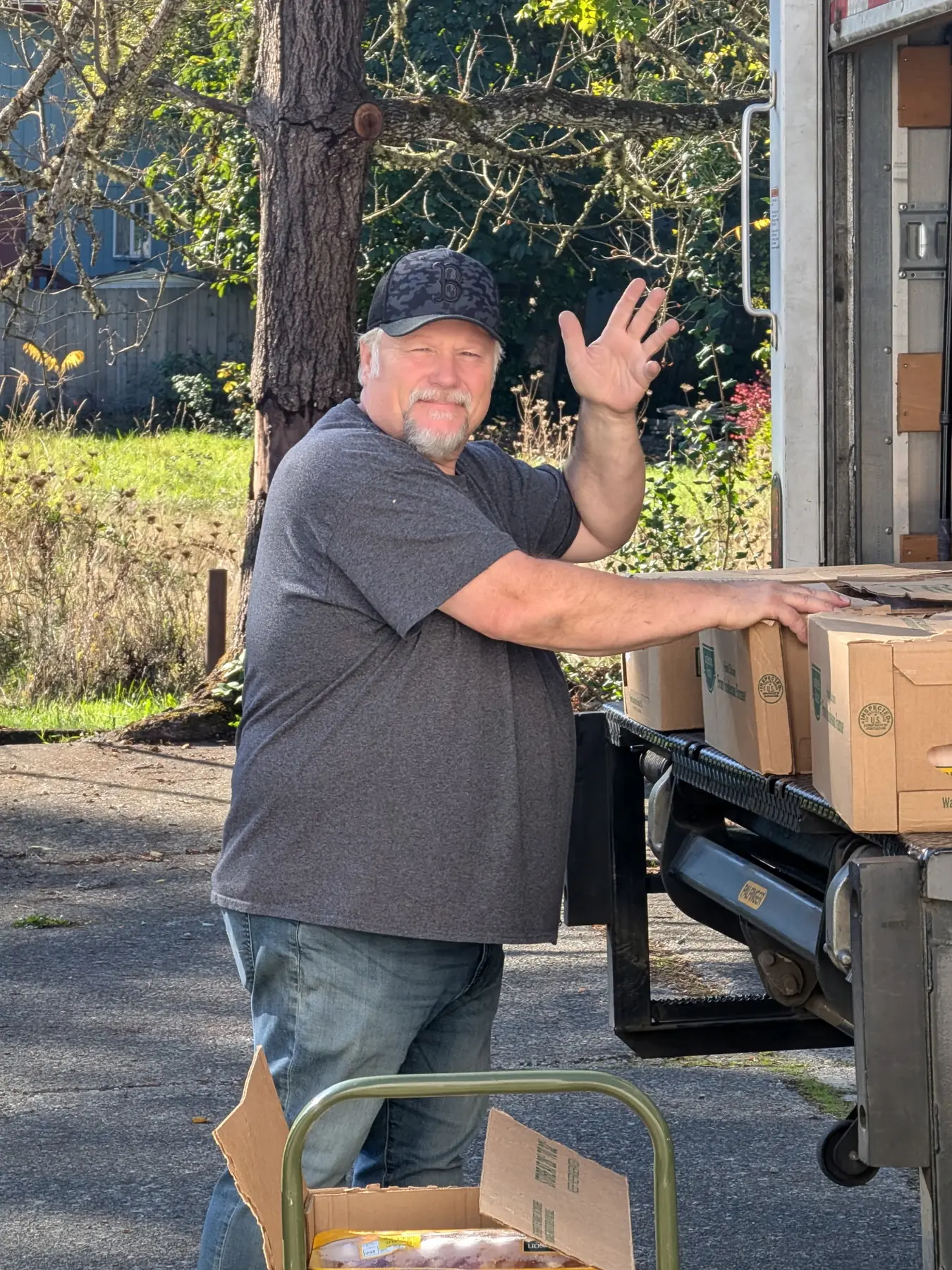 A GG's House volunteer unloading boxes of donated goods from a vehicle