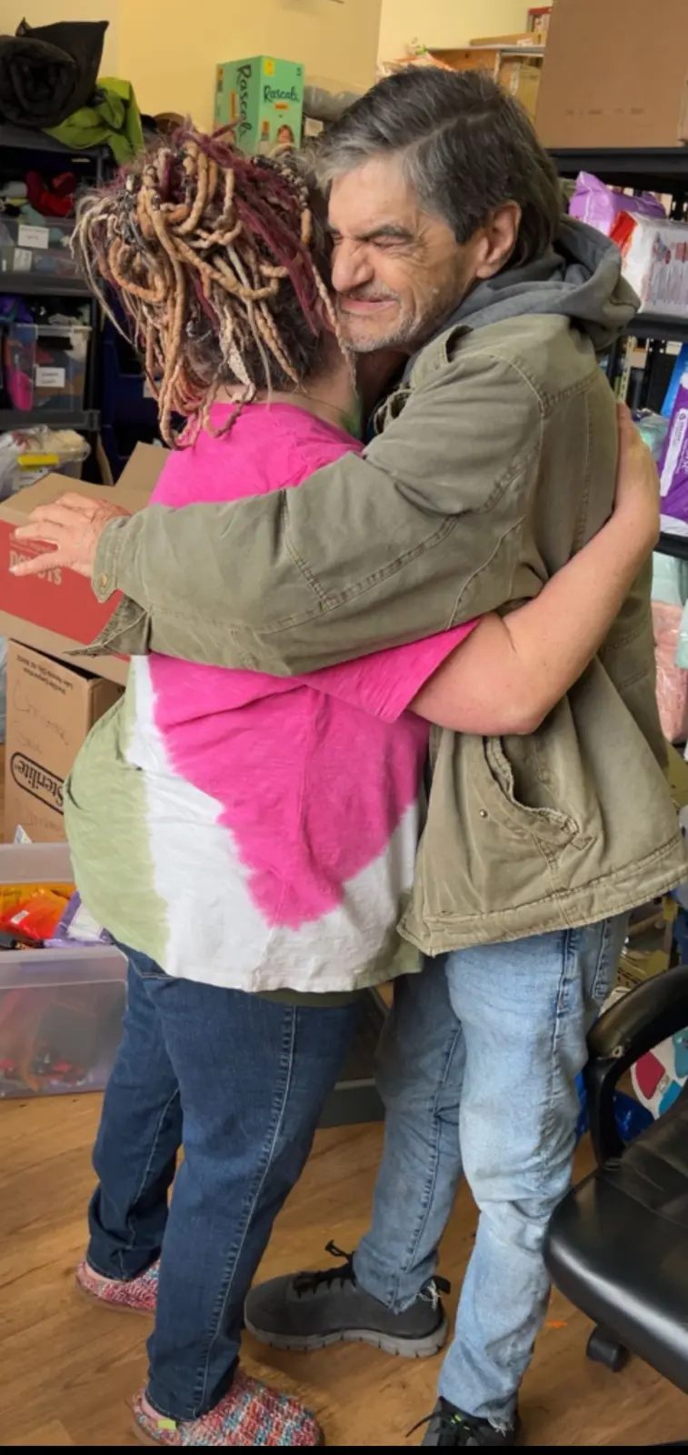 Angel embracing a community member at GG's House