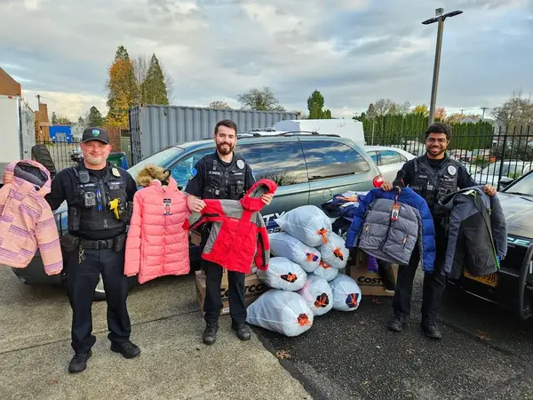 Forest Grove police officers with donated coats and blankets