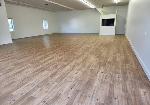 Open interior room at 1714 Pacific Avenue with newly installed wood-look flooring