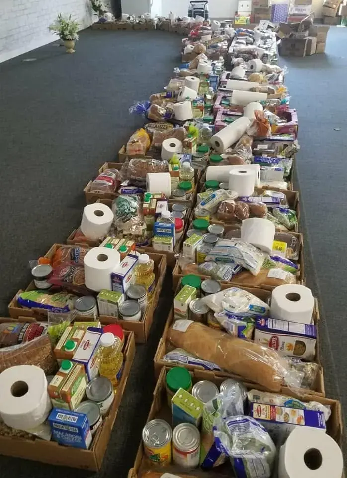 Rows of food boxes prepared with pantry staples and household essentials during GG's House's 2020 COVID response