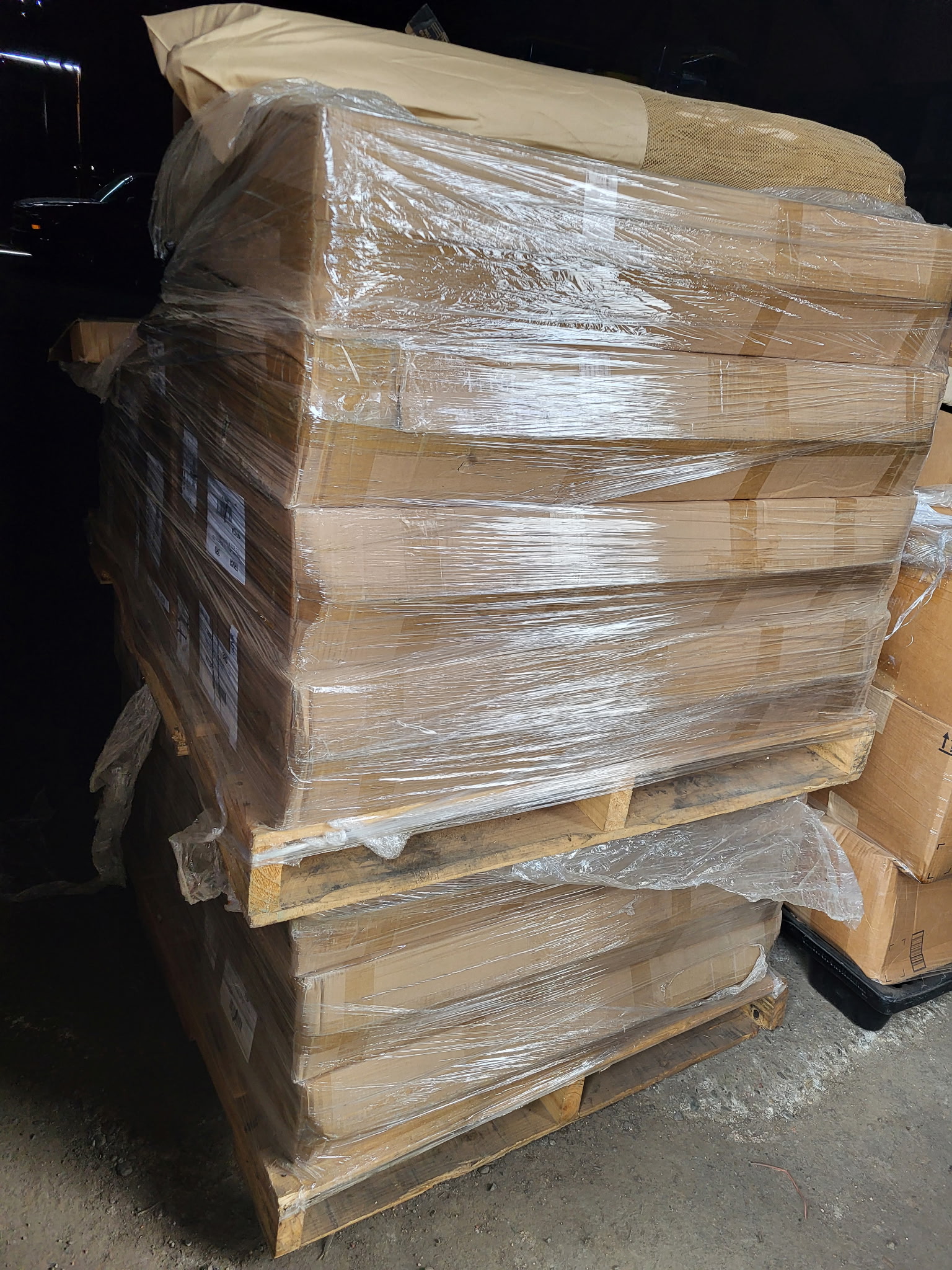 A large wrapped pallet of donated household goods prepared for distribution
