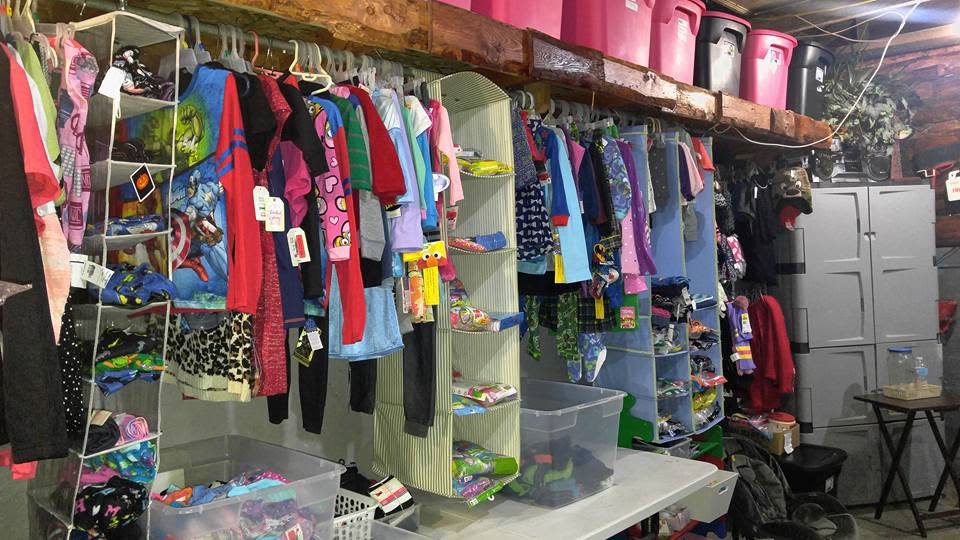 Historic photograph of children's clothing organized at an early GG's House location