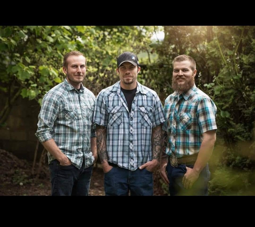 Steve and Angel's three sons standing together outdoors