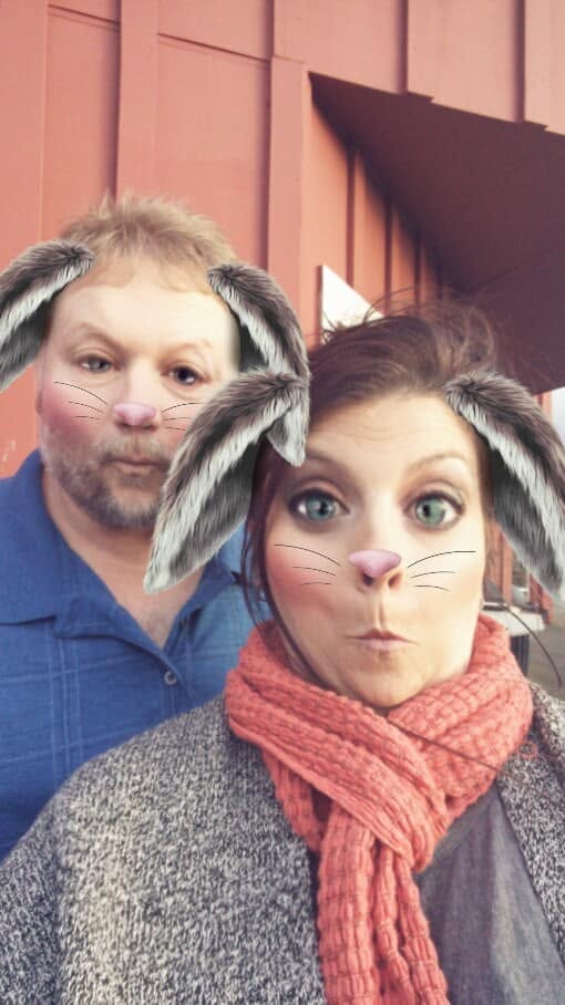 Steve and Angel laughing together with a playful bunny camera filter